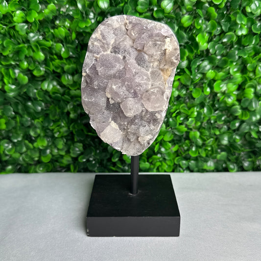 Sugar amethyst piece on a stand